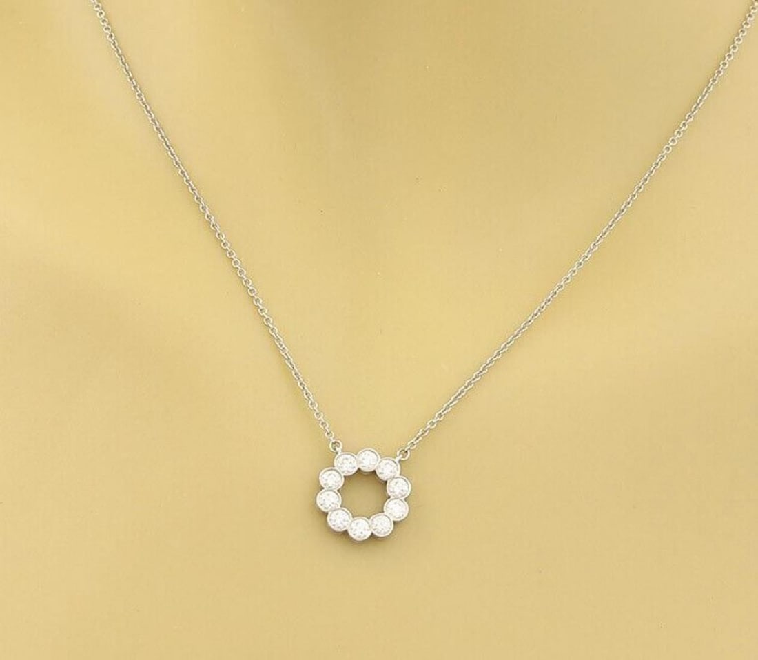 Circle Jazz Pendant Necklace in Platinum with 0.52ct Diamond by Tiffany & Co.: Circle Jazz Pendant Necklace in Platinum with 0.52ct Diamond by Tiffany & Co. This Tiffany & Co. Circle Jazz pendant necklace features a circular design crafted in platinum, set with a 0.52ct diamond.