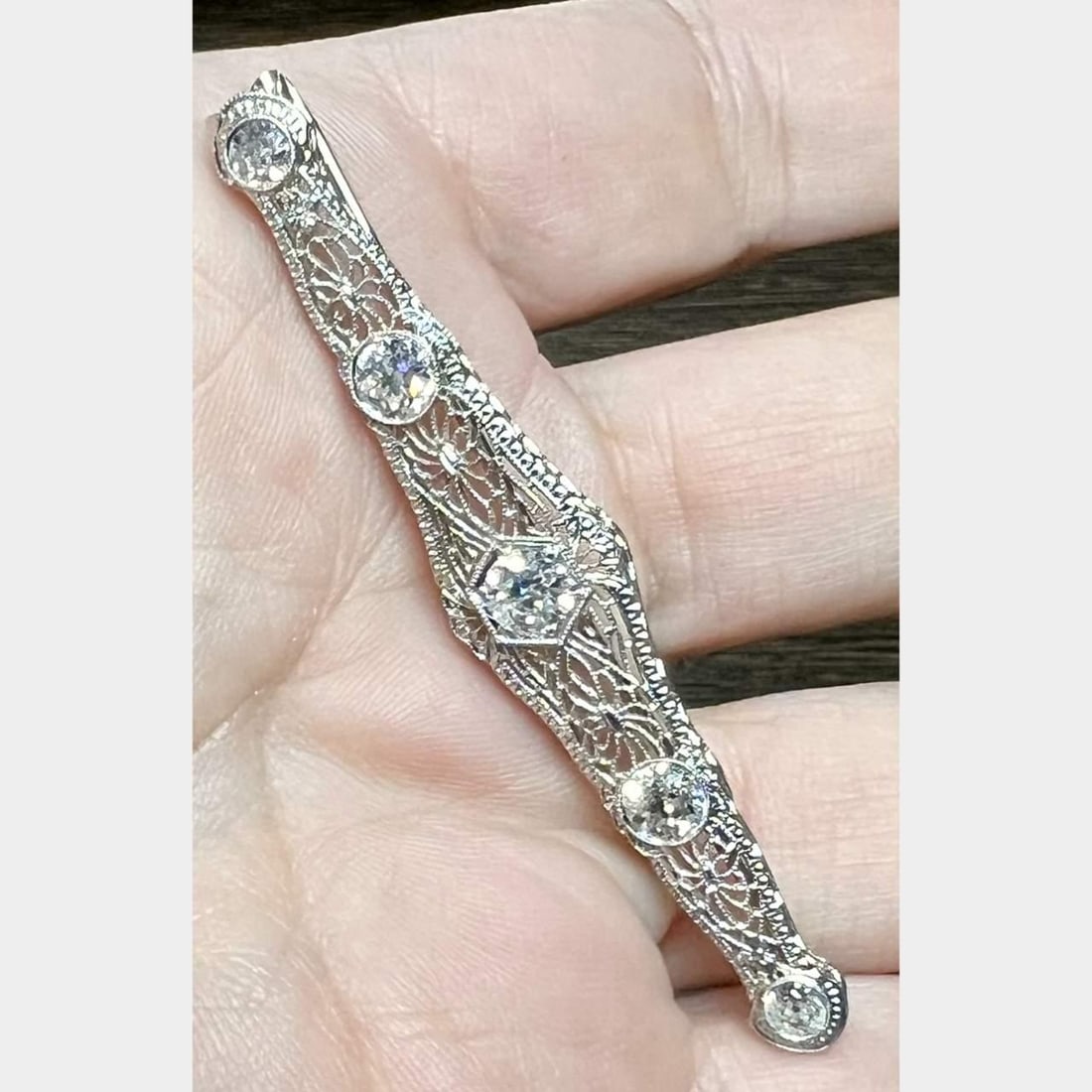 1950s 14K White Gold Filigree Brooch with 5 European-Cut Diamonds: 1950s 14K White Gold Filigree Brooch with 5 European-Cut Diamonds This exquisite 1950's brooch is crafted from 14K white gold and features intricate filigree work. It is adorned with five stunning Eur