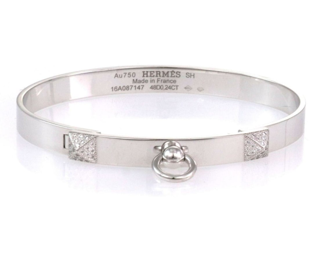 Hermes Collier de Chien Diamond Bangle in 18k White Gold: Hermes Collier de Chien Diamond Bangle in 18k White Gold This Hermes Collier de Chien bangle bracelet showcases refined elegance, featuring 18k white gold set with pave diamonds totaling 0.24ct. As pa