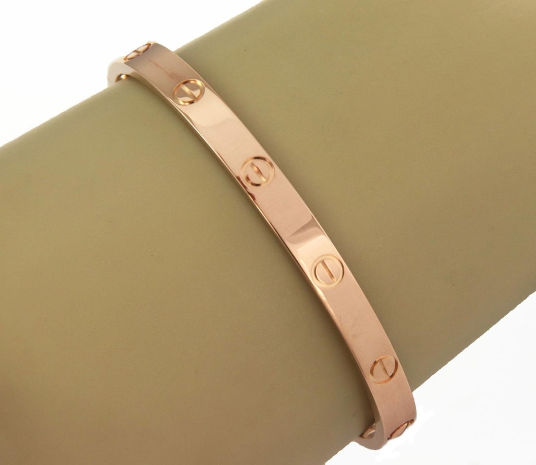 Cartier 18k Pink Gold Love Bangle Bracelet Size 19 with Screwdriver: Cartier 18k Pink Gold Love Bangle Bracelet Size 19 with Screwdriver This exquisite bangle bracelet from Cartier's iconic LOVE collection is crafted from 18k pink gold with a high polished finish. Its
