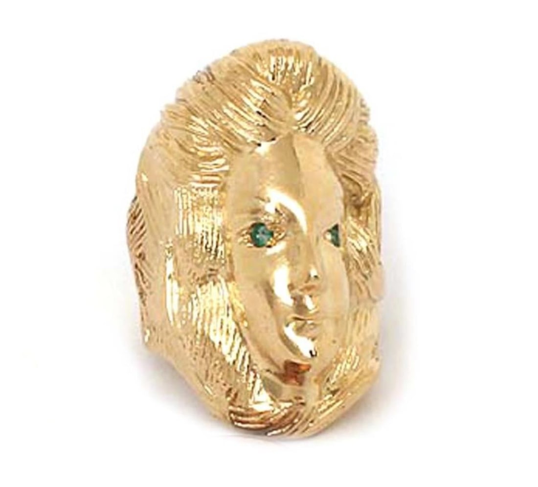Emerald Adorned Woman Face Ring in 14k Yellow Gold Size 6.5: Emerald Adorned Woman Face Ring in 14k Yellow Gold Size 6.5 This vintage ring showcases a large woman's face design crafted from 14k yellow gold and adorned with emeralds. The ring is hallmarked 14k a