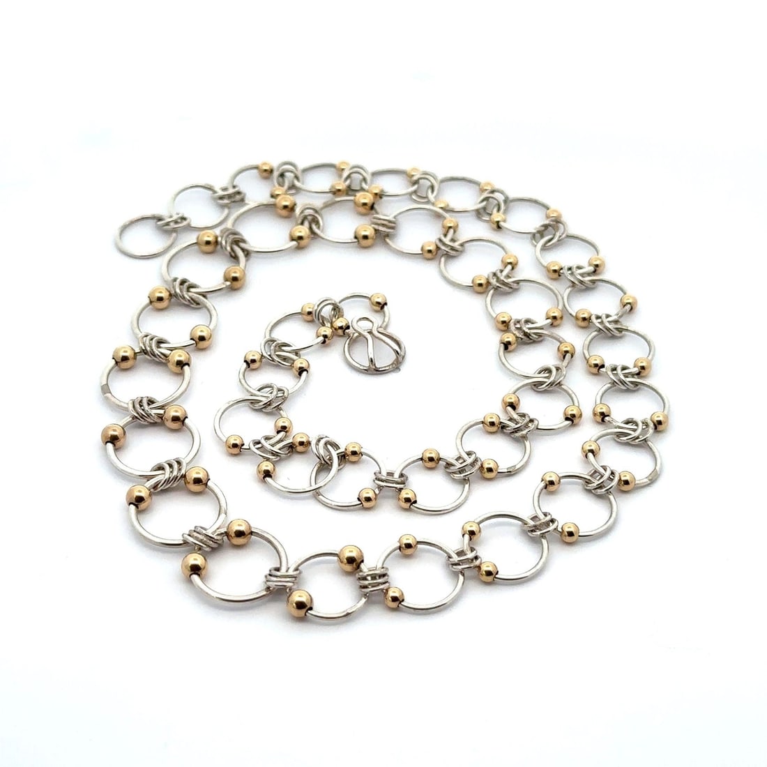 10k Yellow Gold Sterling Silver Graduated Circle Link Necklace 20in: 10k Yellow Gold Sterling Silver Graduated Circle Link Necklace 20in This exquisite necklace features a unique design with graduated interlocking open circle links, crafted from sterling silver and acc
