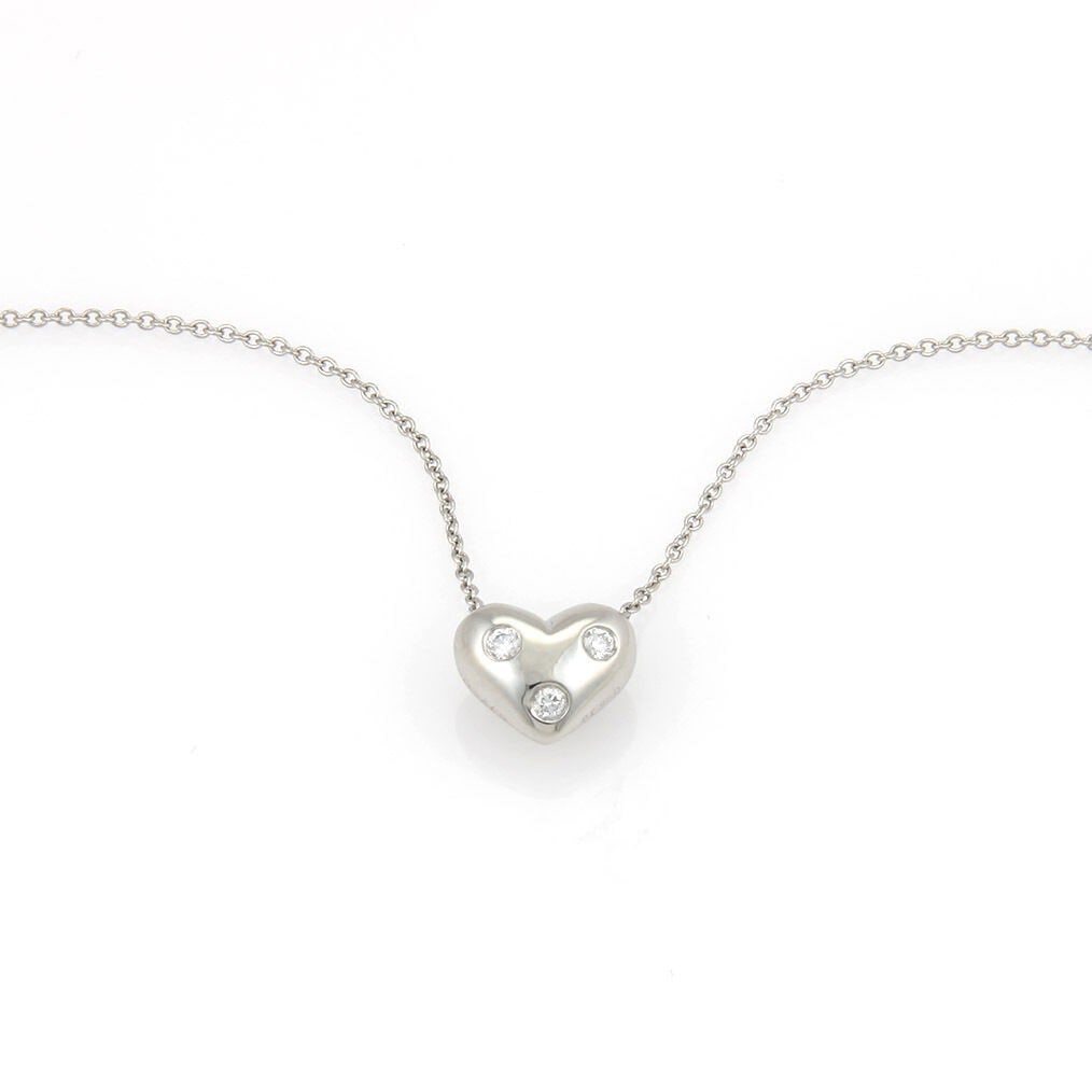 Platinum Heart Pendant Necklace with Three Diamonds Etoile Collection: Platinum Heart Pendant Necklace with Three Diamonds Etoile Collection This Tiffany & Co. Etoile Diamond Platinum 3 Stone Heart Slide Pendant Necklace features a heart-shaped pendant set with three bri