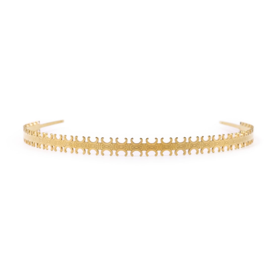 CELINE Gold Metal Hairband Fashion Accessory: CELINE Gold Metal Hairband Fashion Accessory This CELINE hairband is a stylish accessory crafted from high-quality materials and features a stunning gold finish. It is designed for regular sizing, mak