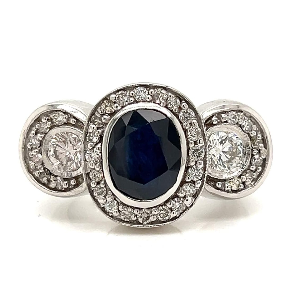 14k White Gold Sapphire 3.00 Ct Diamond Ring with 34 Stones: 14k White Gold Sapphire 3.00 Ct Diamond Ring with 34 Stones This exquisite 14k white gold ring features a stunning central sapphire weighing approximately 3.00 Ct, complemented by two diamonds totalin
