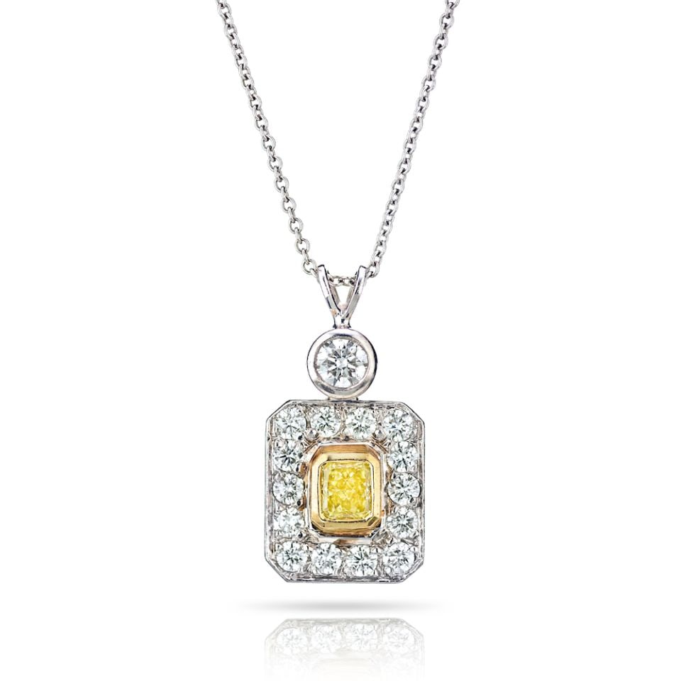 GIA Certified Fancy Yellow Diamond Halo Pendant in Platinum and 18K Gold: GIA Certified Fancy Yellow Diamond Halo Pendant in Platinum and 18K Gold This exquisite pendant features a stunning combination of platinum and 18K yellow gold, showcasing a radiant cut fancy yellow d