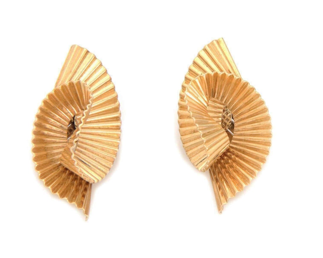 14k Yellow Gold Fluted Ribbon Twist Clip-On Earrings by Tiffany & Co.: 14k Yellow Gold Fluted Ribbon Twist Clip-On Earrings by Tiffany & Co. These Tiffany & Co. earrings are crafted from 14k yellow gold in a fluted ribbon twist design. Featuring a huggie style silhouette