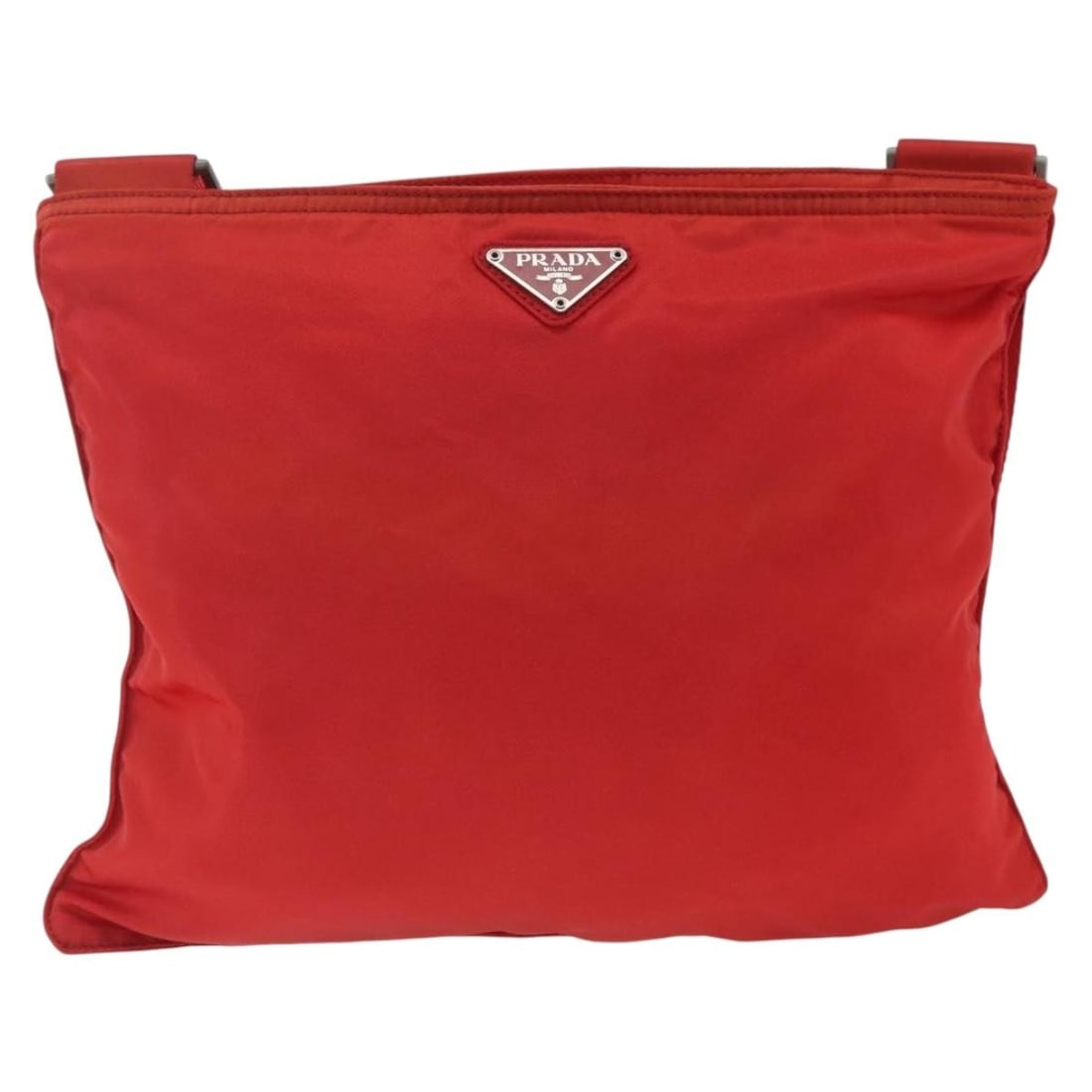 Red Nylon Unisex Messenger Bag by Prada with Zip Closure: Red Nylon Unisex Messenger Bag by Prada with Zip Closure This Prada Zip Top Messenger Bag is made of red nylon with metal fittings. Designed for unisex use, it features a zip-top closure and an adjust