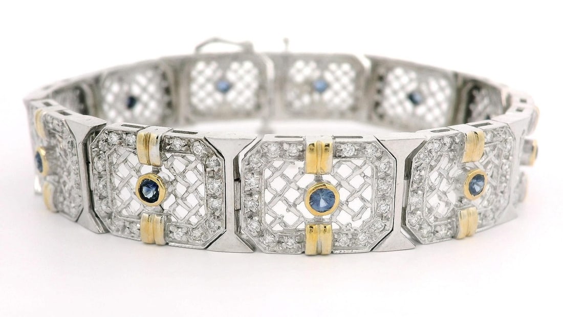 14k White Gold Filigree Bracelet 2.51ct Diamond 0.75ct Sapphire: 14k White Gold Filigree Bracelet 2.51ct Diamond 0.75ct Sapphire This stunning bracelet features an intricate filigree open work design, crafted from solid 14k white gold with yellow gold accents. It s