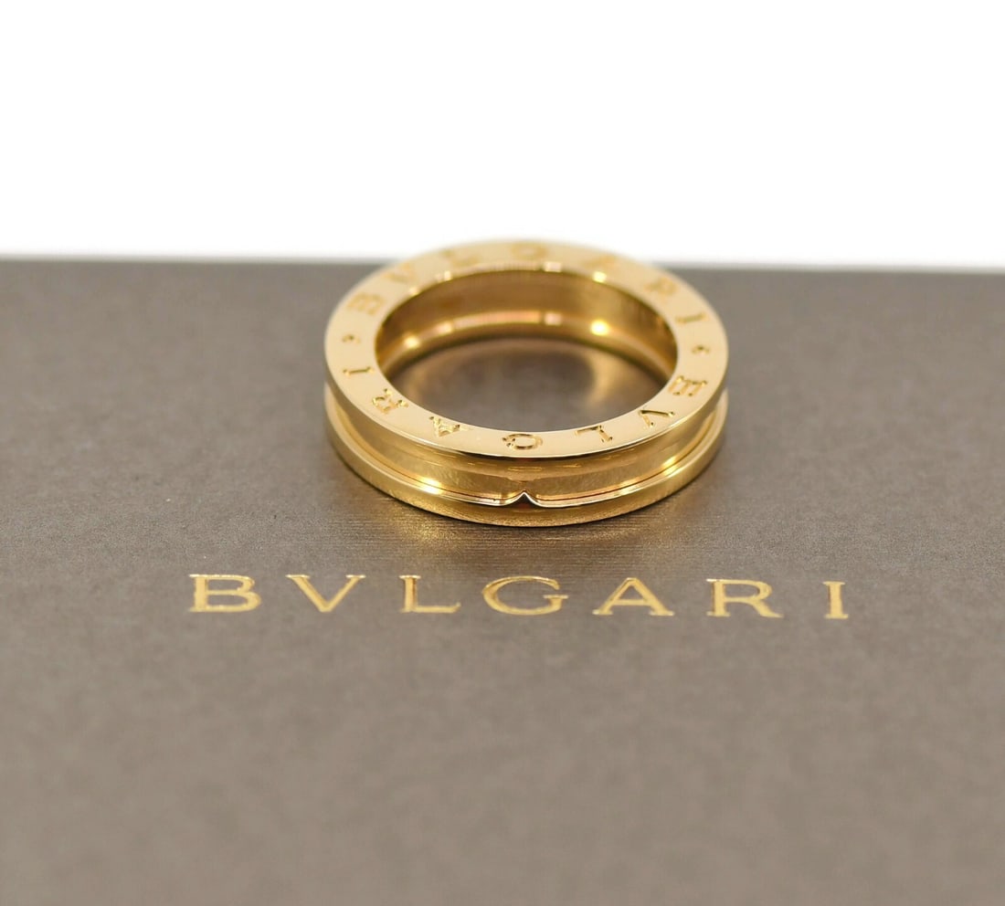 Bulgari B.Zero1 18K Yellow Gold Ring Authentic with Box and Certificate: Bulgari B.Zero1 18K Yellow Gold Ring Authentic with Box and Certificate Introducing the exquisite Bulgari B.Zero1 Ring, crafted from luxurious 18K yellow gold. This timeless piece from the renowned Bv