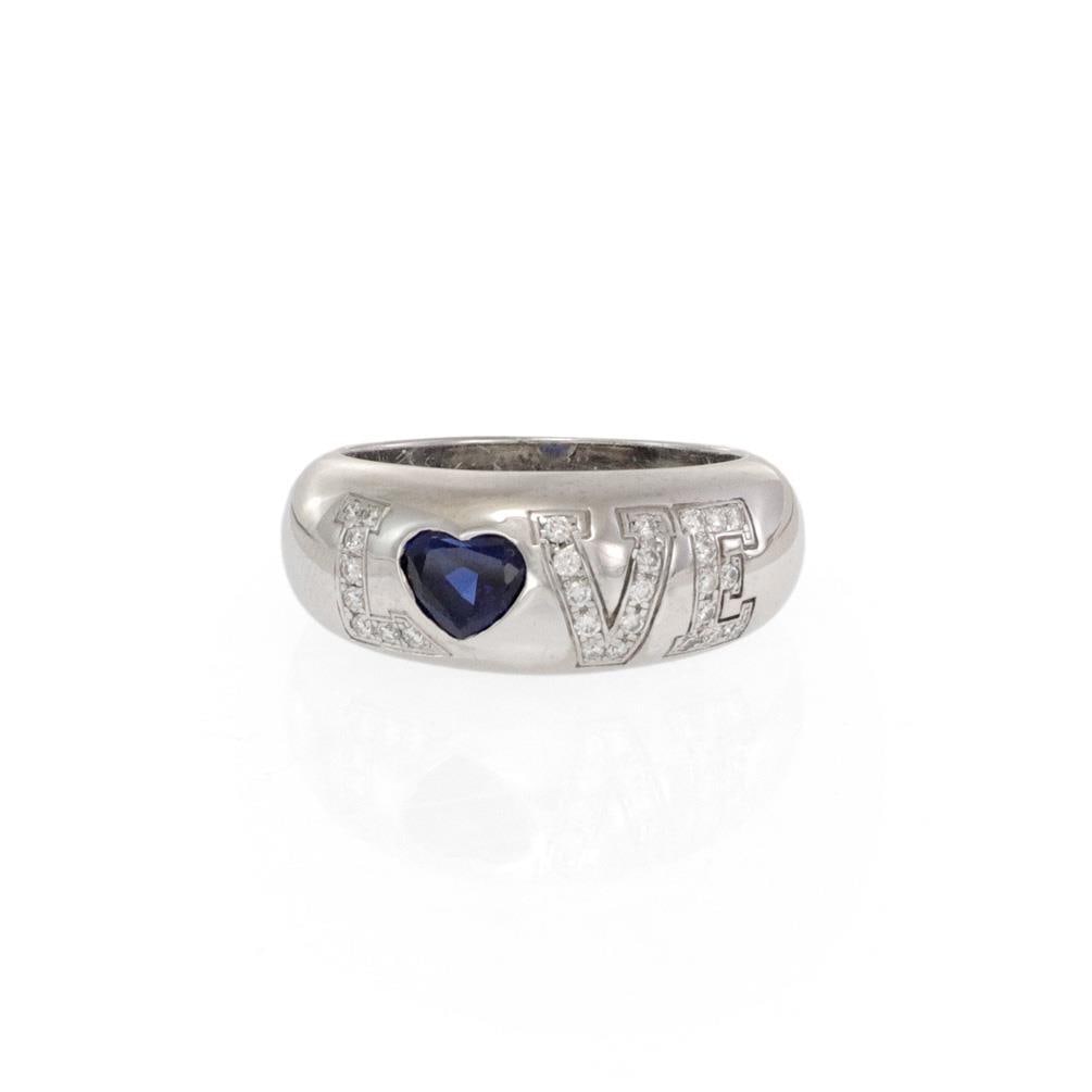Chopard LOVE Diamond Blue Sapphire 18k White Gold Dome Band Ring: Chopard LOVE Diamond Blue Sapphire 18k White Gold Dome Band Ring This exquisite dome band ring by Chopard is crafted from 18k white gold, featuring a high polished finish. The front of the tapered dom