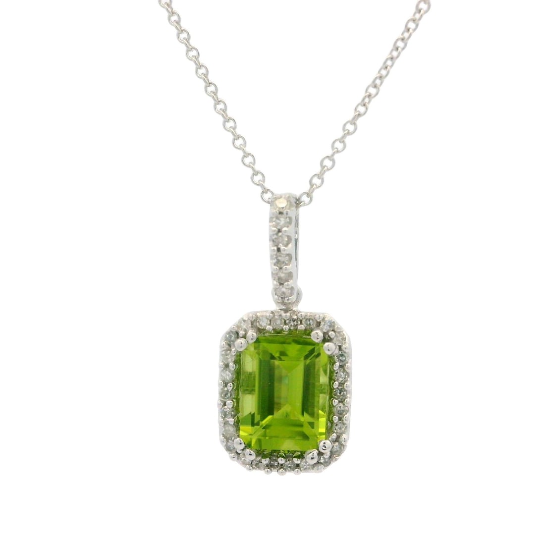 Estate 14k White Gold Peridot Diamond Pendant Necklace: Estate 14k White Gold Peridot Diamond Pendant Necklace This exquisite estate pendant necklace showcases a stunning rectangular step cut peridot framed by numerous round brilliant cut diamonds. The viv