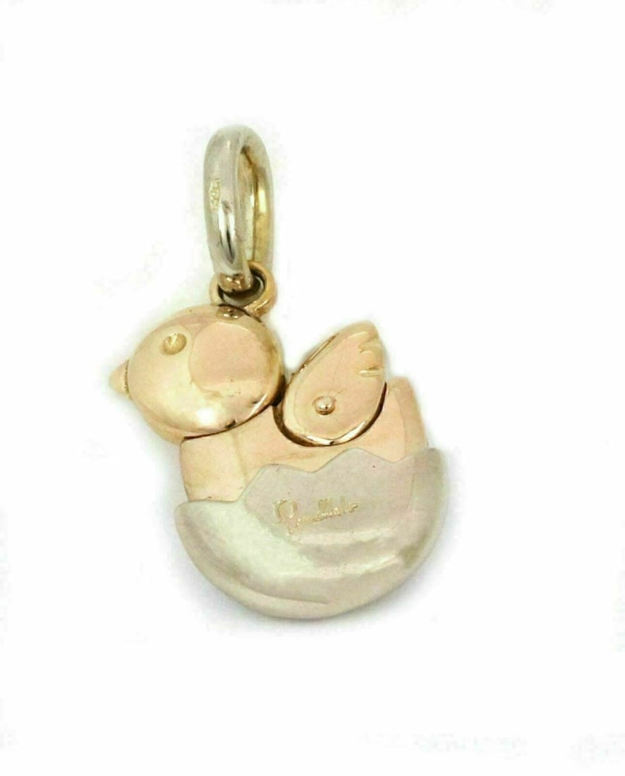 Pomellato 18k Two Tone Gold Animated Chick Charm Pendant: Pomellato 18k Two Tone Gold Animated Chick Charm Pendant This Pomellato pendant is crafted from 18k two-tone yellow and white gold and features an animated baby chicken charm emerging from a shell. Th