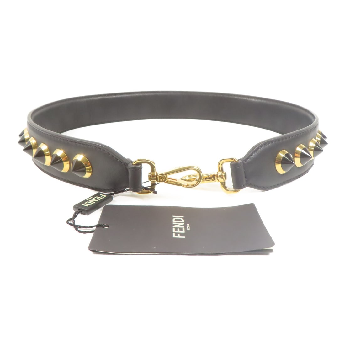 Fendi Black Calfskin Shoulder Strap with Gold Hardware: Fendi Black Calfskin Shoulder Strap with Gold Hardware Elevate your style with this Fendi shoulder strap, crafted from luxurious calfskin leather. The strap features a striking black finish complement