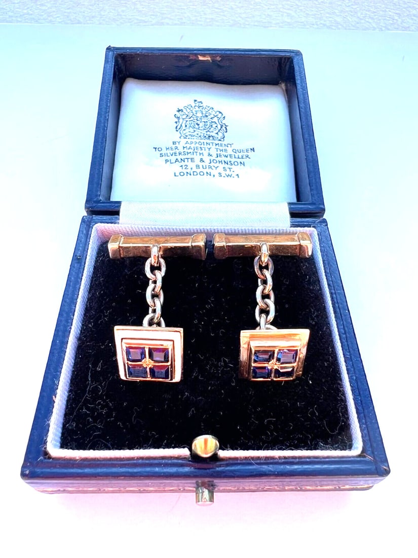 Elegant English 18K Gold Sapphire Enamel Cufflinks with Box: Elegant English 18K Gold Sapphire Enamel Cufflinks with Box This exquisite pair of English cufflinks is crafted from 18K gold and features stunning sapphires and enamel detailing. Each cufflink is ado