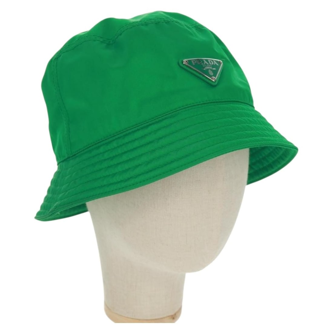 Green Nylon Bucket Hat by PRADA Made in Italy: Green Nylon Bucket Hat by PRADA Made in Italy This PRADA bucket hat features a vibrant green nylon exterior and is crafted in Italy. The hat offers a head circumference of approximately 59 cm (23.2 in