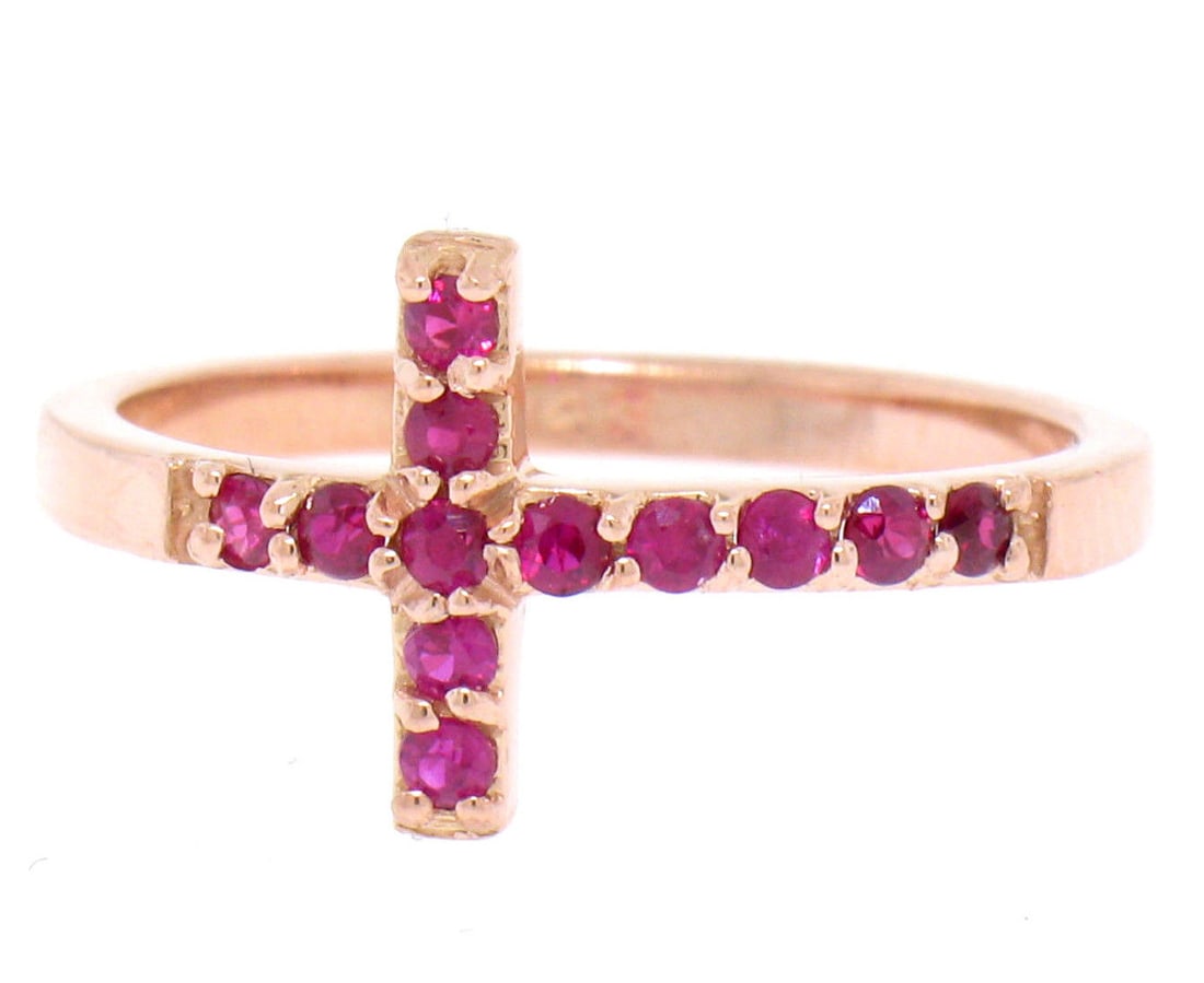 14k Rose Gold 0.25ctw Blood Red Ruby Curved Cross Band Ring: 14k Rose Gold 0.25ctw Blood Red Ruby Curved Cross Band Ring This exquisite ring features a stunning curved cross design crafted from solid 14k rose gold. Adorning the band are twelve natural, round br
