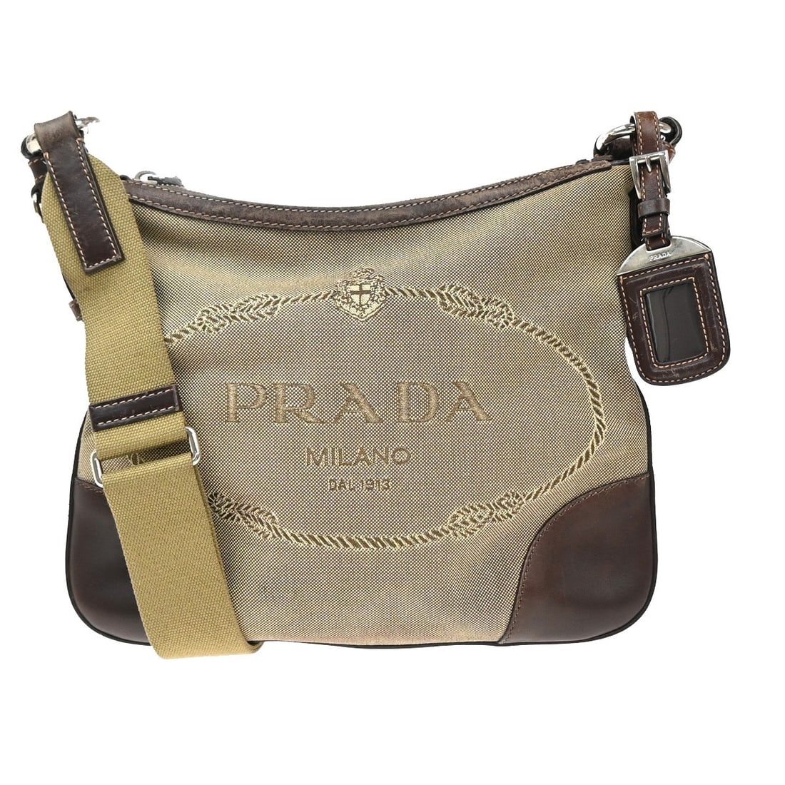 Prada Beige Canvas Crossbody Logo Bag 27cm x 22cm: Prada Beige Canvas Crossbody Logo Bag 27cm x 22cm This Prada Logo Crossbody Bag is crafted from beige canvas and designed for women. Made in Italy, it features a practical crossbody style with the Pra