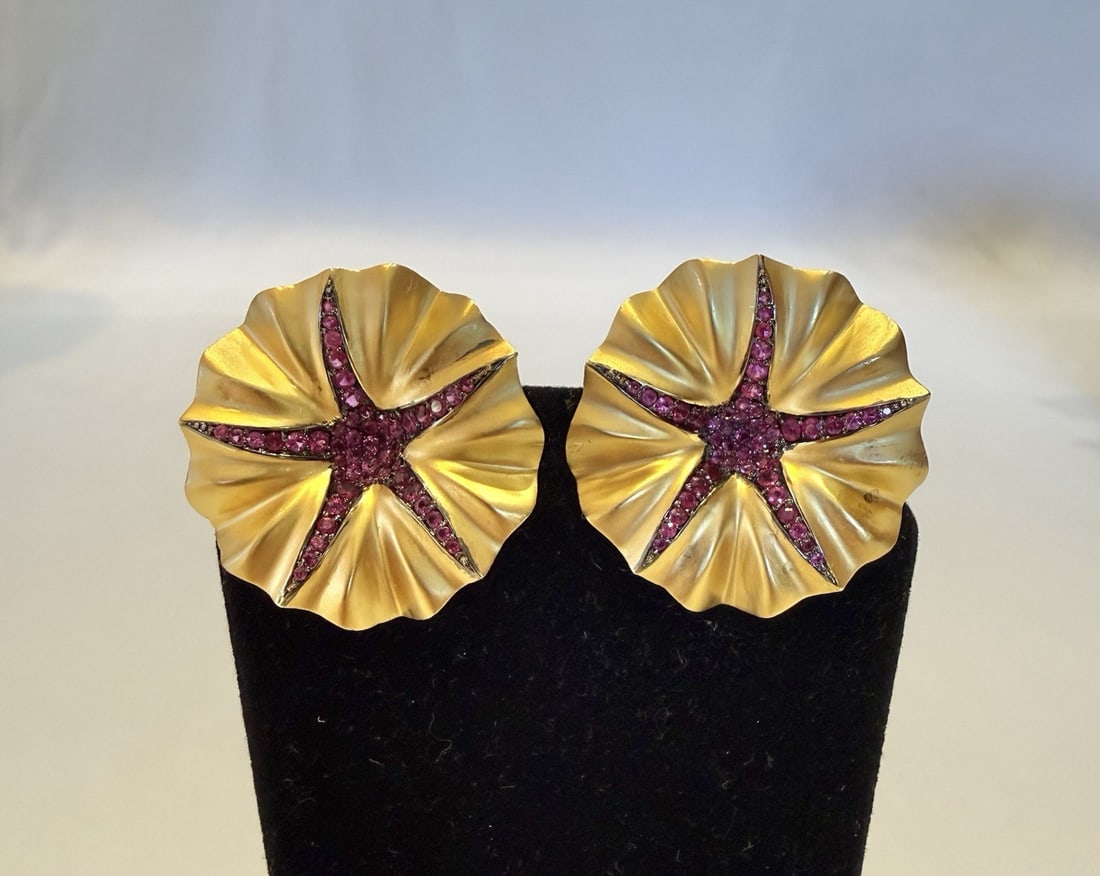 Pair of French 18K Yellow Gold Ruby Cuff Earrings: Pair of French 18K Yellow Gold Ruby Cuff Earrings This is a large pair of French cuff-style earrings crafted from 18K yellow gold, featuring a total of 2.15 carats of rubies. The earrings are signed a