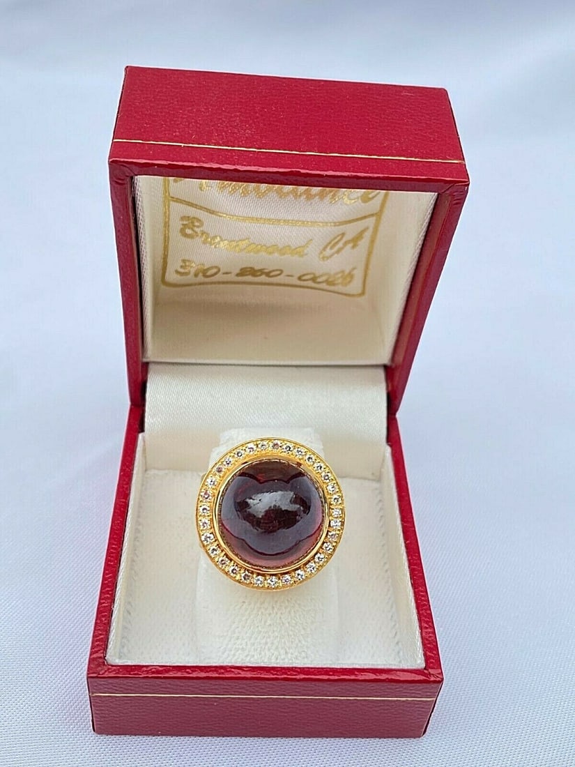 1960s French 18K Gold Diamond Garnet Ring Size 6: 1960s French 18K Gold Diamond Garnet Ring Size 6 This exquisite French ring from the 1960s showcases a stunning combination of 18K yellow gold, a brilliant diamond, and a large garnet. The garnet meas