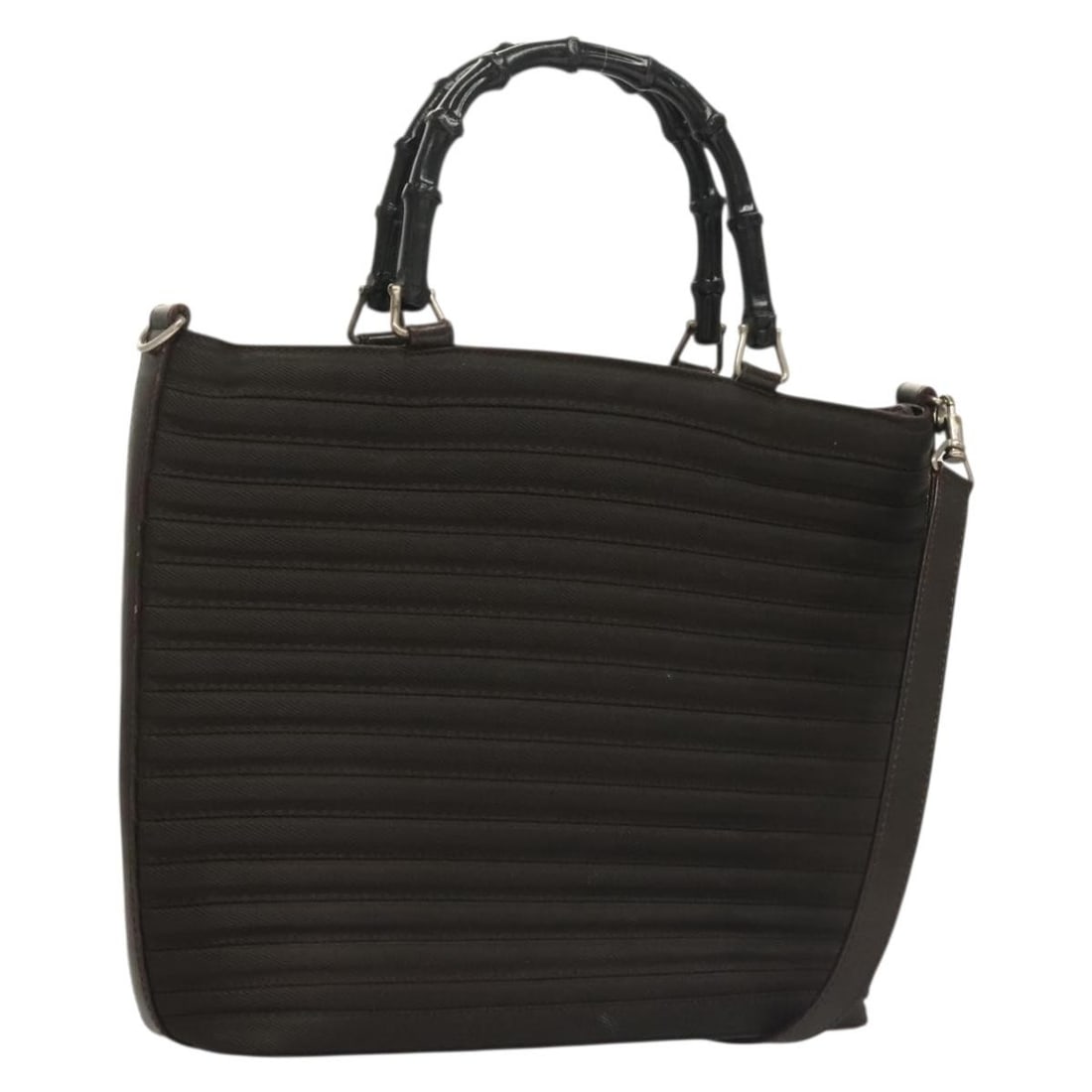 Brown Nylon Gucci Vintage Bag with Bamboo Handles: Brown Nylon Gucci Vintage Bag with Bamboo Handles This Gucci Vintage Bamboo Handle Bag features a brown nylon exterior with signature bamboo handles, designed for women. The bag shows signs of wear, i