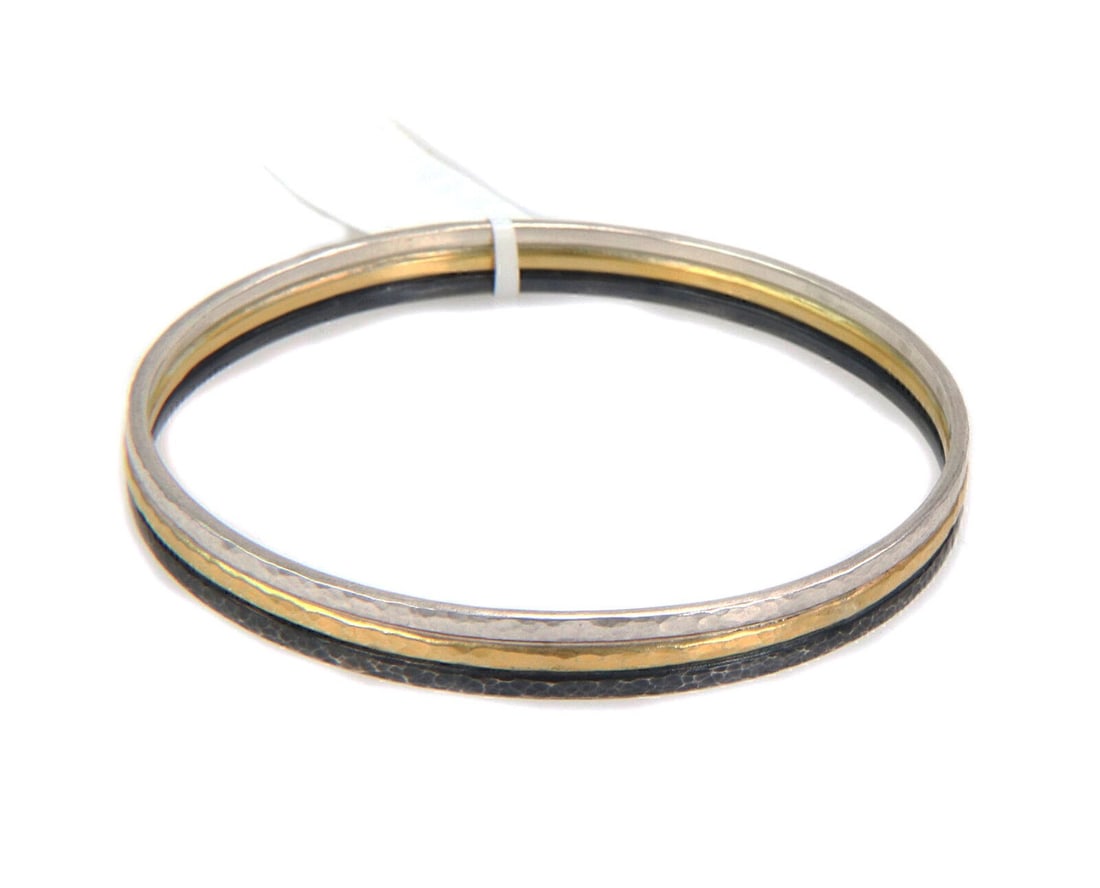 Sterling Silver Bangle Bracelet with 24k Gold Overlay by Gurhan Skittle: Sterling Silver Bangle Bracelet with 24k Gold Overlay by Gurhan Skittle This Gurhan Skittle bangle bracelet showcases a sophisticated design with a 24k gold overlay on sterling silver, offering a stri