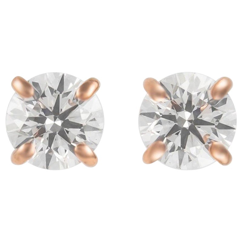 0.92 Carat Diamond Stud Earrings in 14k Rose Gold: 0.92 Carat Diamond Stud Earrings in 14k Rose Gold Elevate your elegance with these stunning 0.92 carat diamond stud earrings, crafted in luxurious 14k rose gold. These modern earrings feature two roun