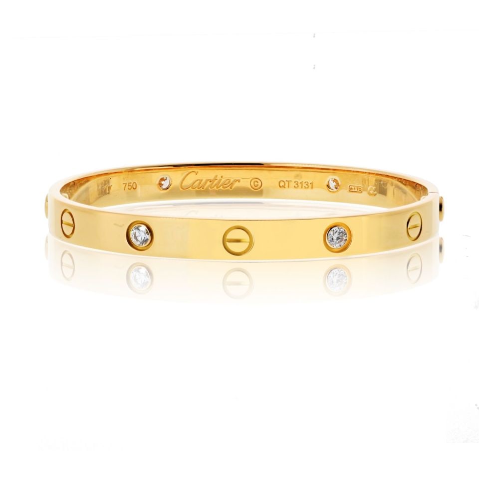 Vintage Cartier Love 18K Yellow Gold Bracelet with Four Diamonds Size 17: Vintage Cartier Love 18K Yellow Gold Bracelet with Four Diamonds Size 17 This vintage Cartier Love bracelet is crafted from 18K yellow gold and features four round diamonds. The classic design include