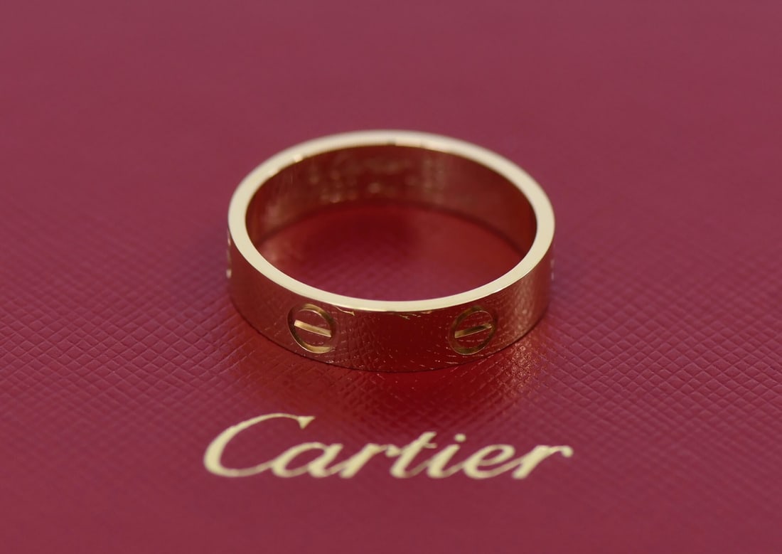 Cartier Love Band 18K Yellow Gold Size 63 with Box and Service Receipt: Cartier Love Band 18K Yellow Gold Size 63 with Box and Service Receipt This Cartier Love Ring is crafted from 18K yellow gold and features the iconic Love motif. The ring is a size 63 (US 10.5), measu