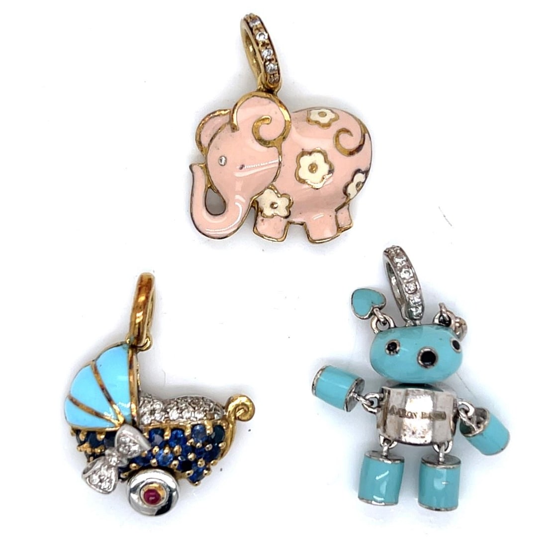 Set of Three Aaron Basha 18K Gold Charms: Set of Three Aaron Basha 18K Gold Charms This Aaron Basha set features three charms crafted in 18K gold. The combined weight of the charms is 23.1 grams, and each charm measures between 0.75 and 1 inc