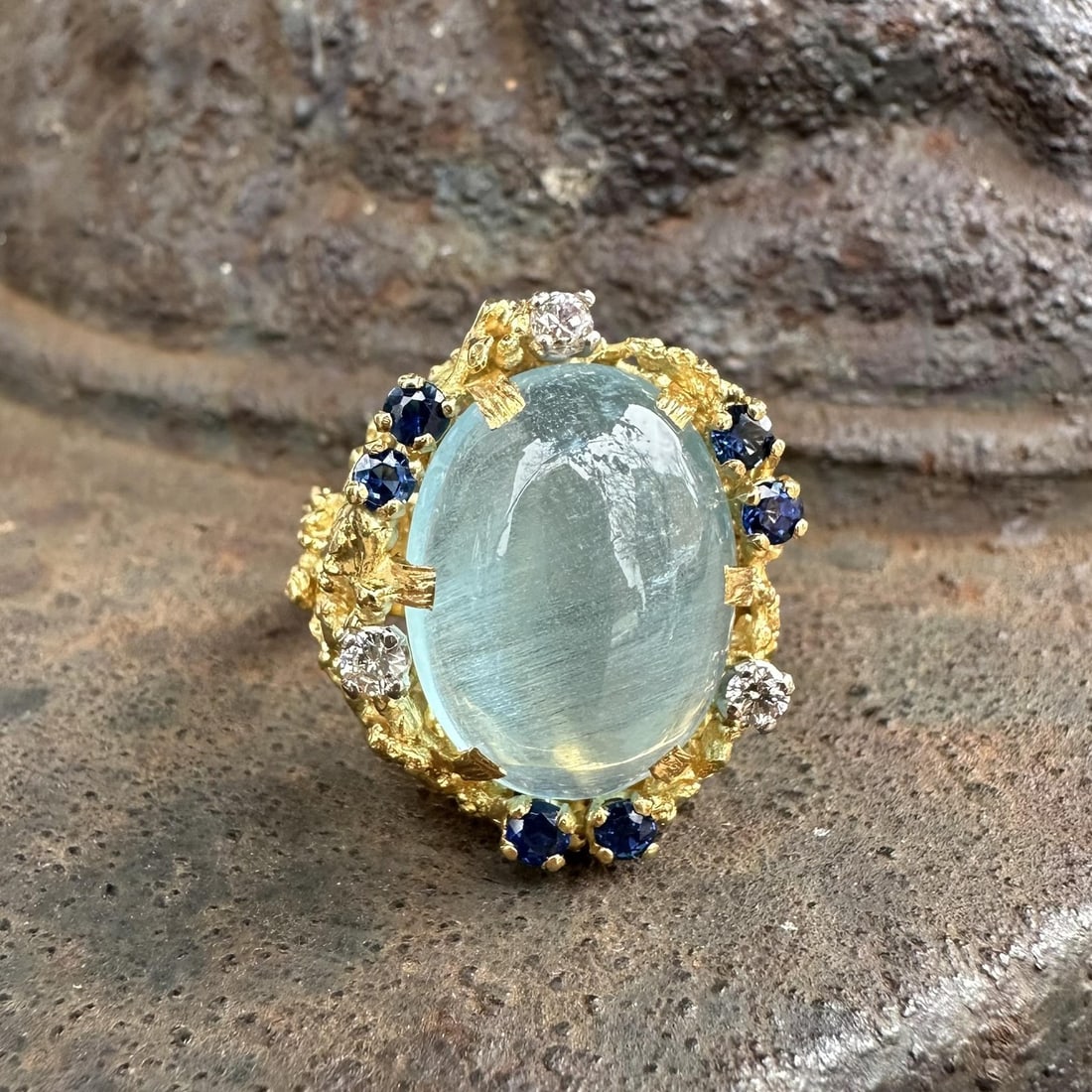 18k Yellow Gold GIA Cat's Eye Aquamarine Sapphire Diamond English Cocktail Ring: 18k Yellow Gold GIA Cat's Eye Aquamarine Sapphire Diamond English Cocktail Ring This vintage English cocktail ring is crafted from solid 18k yellow gold and features a GIA-certified natural cat's eye