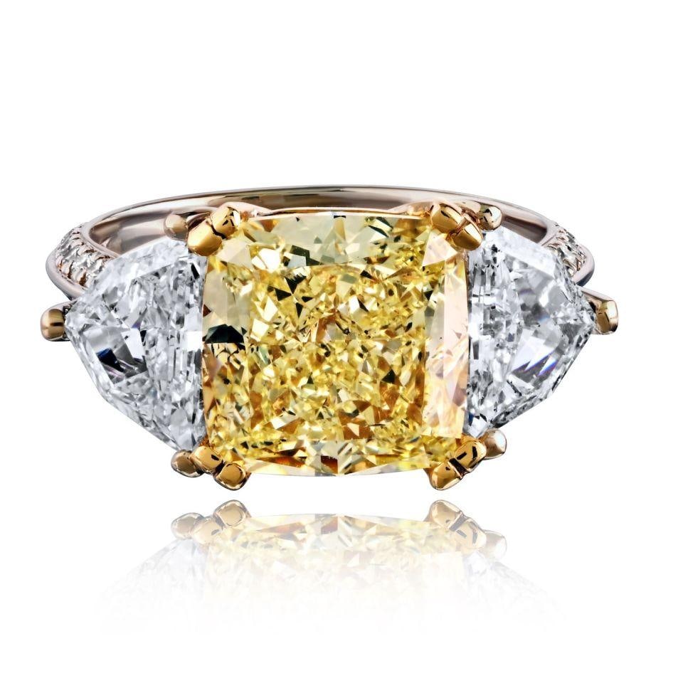 Radiant Cut 5.02 Carat Fancy Yellow Diamond 18K Two Tone Ring GIA: Radiant Cut 5.02 Carat Fancy Yellow Diamond 18K Two Tone Ring GIA This pre-owned ring features a 5.02 carat radiant cut fancy yellow diamond set in 18K two-tone metal. The elegant design showcases the