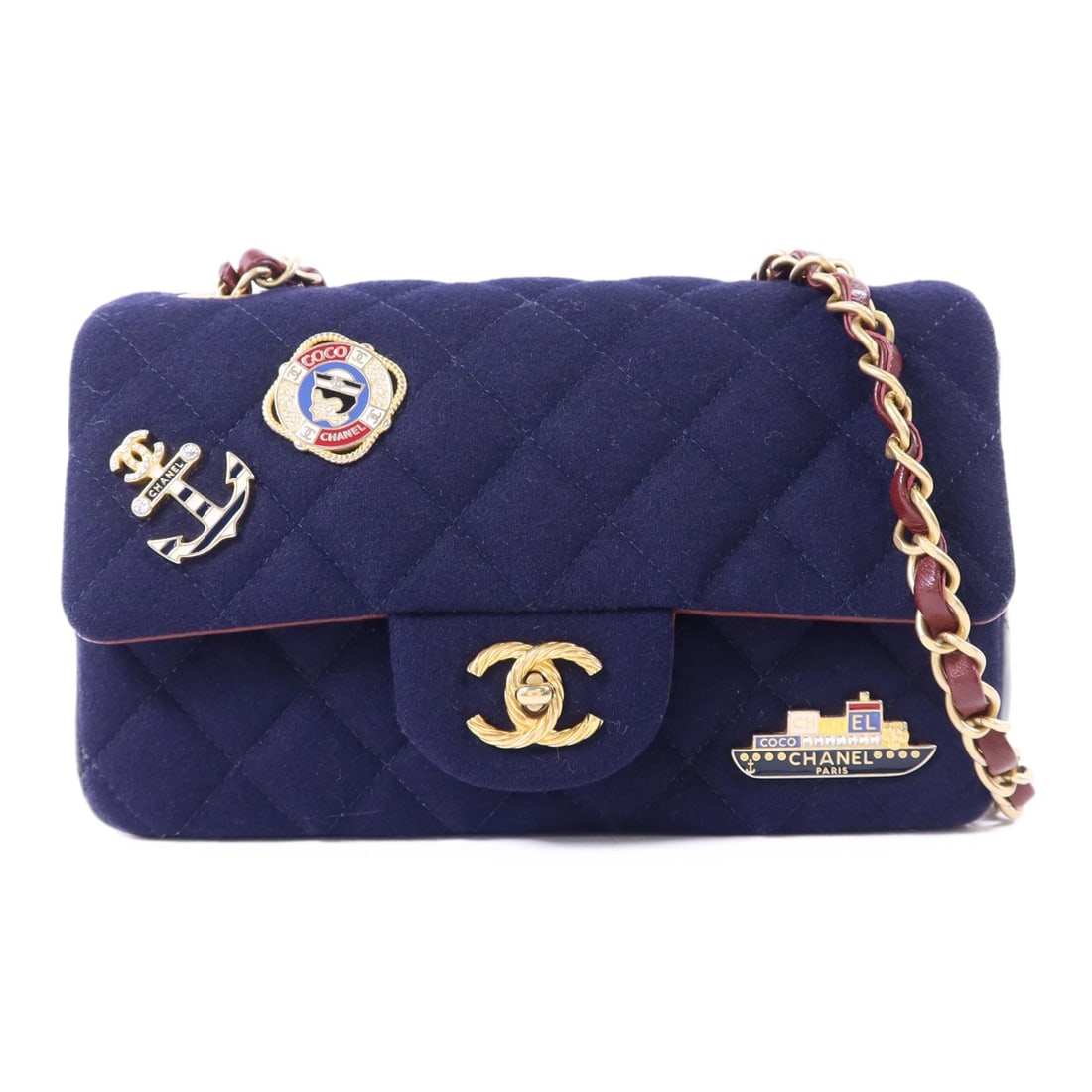 Chanel Mini Flap Wool Shoulder Bag with Paris Hamburg Charms Navy: Chanel Mini Flap Wool Shoulder Bag with Paris Hamburg Charms Navy This CHANEL CC Paris Hamburg Charms Mini Flap Bag features a navy wool exterior and gold-tone hardware. Designed as a chain shoulder b