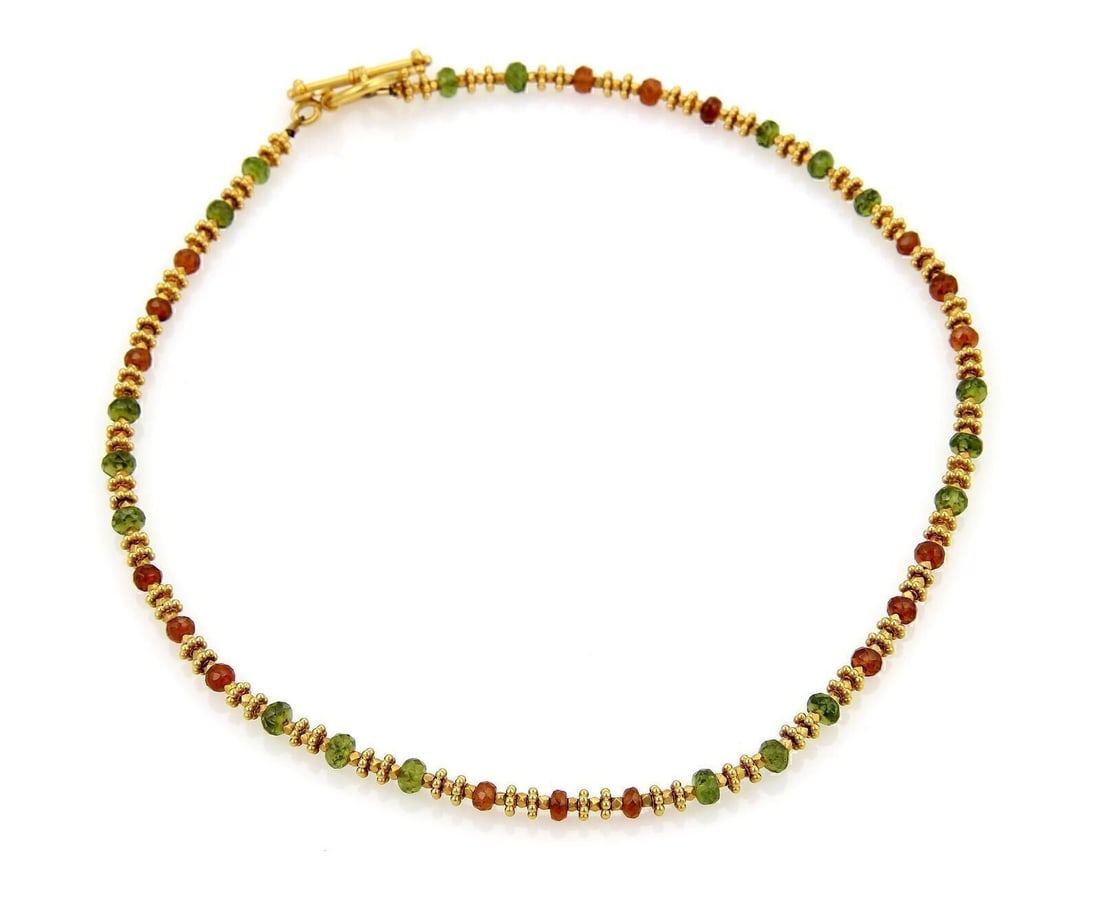 Beaded Necklace in 22k Yellow Gold with Orange and Green Faceted Accents by Laura Gibson: Beaded Necklace in 22k Yellow Gold with Orange and Green Faceted Accents by Laura Gibson This original beaded necklace by Laura Gibson features vibrant orange and green faceted beads arranged in a fra