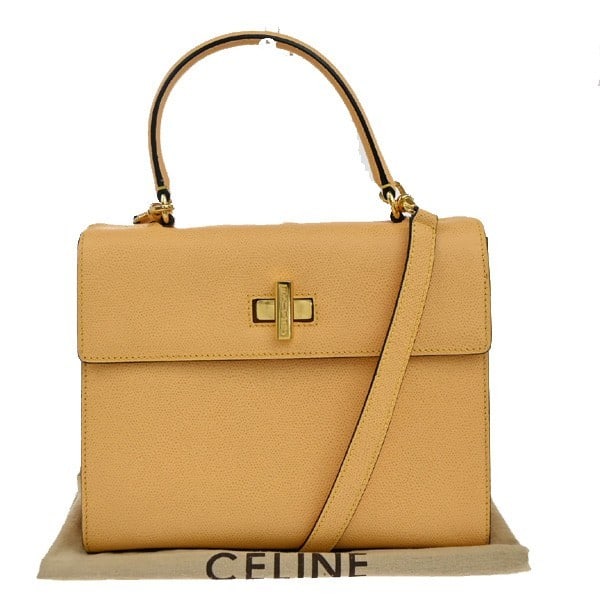 Celine Yellow Leather Vintage Turnlock Convertible Top Handle Bag: Celine Yellow Leather Vintage Turnlock Convertible Top Handle Bag This Celine vintage convertible turnlock top handle bag features yellow leather and a classic top handle design. Made in Italy, it is