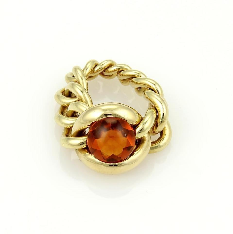 Chanel 18k Yellow Gold 4ct Citrine Chain Link Ring: Chanel 18k Yellow Gold 4ct Citrine Chain Link Ring This exquisite Chanel ring showcases a stunning 4-carat cabochon cut Citrine gemstone, prominently set at the center of a flexible curb design chain