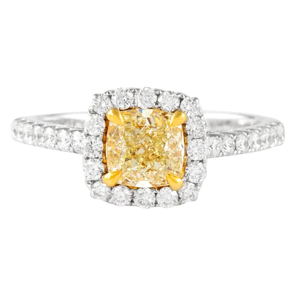 EGL Certified 1.03ct Fancy Vivid Yellow Cushion Diamond Ring in 18k Gold: EGL Certified 1.03ct Fancy Vivid Yellow Cushion Diamond Ring in 18k Gold This contemporary ring features a 1.03 carat cushion cut Fancy Vivid Yellow diamond with SI1 clarity, certified by EGL. The cen