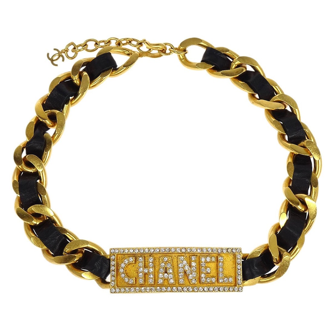 Chanel 95P Gold Plated Black Leather Rhinestone Choker Necklace: Chanel 95P Gold Plated Black Leather Rhinestone Choker Necklace Elevate your jewelry collection with this exquisite Chanel choker necklace. Crafted from gold-plated materials, it features a stunning b