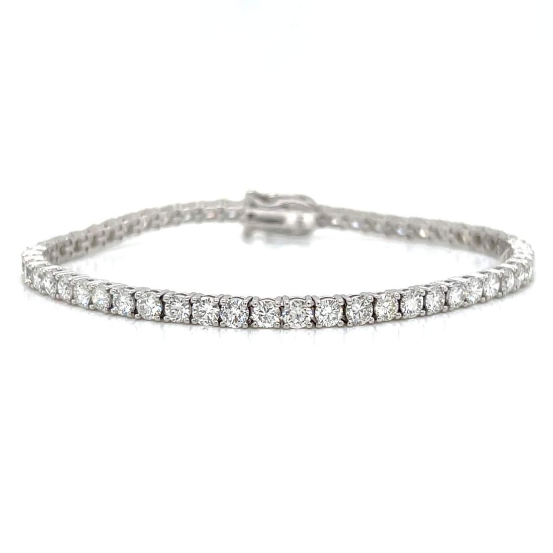 14K White Gold 6.40 Ct Diamond Tennis Bracelet 53 Diamonds F-G VS1-VS2: 14K White Gold 6.40 Ct Diamond Tennis Bracelet 53 Diamonds F-G VS1-VS2 Elevate your elegance with this stunning 14K White Gold Diamond Tennis Bracelet. This exquisite piece features a total of 53 bril