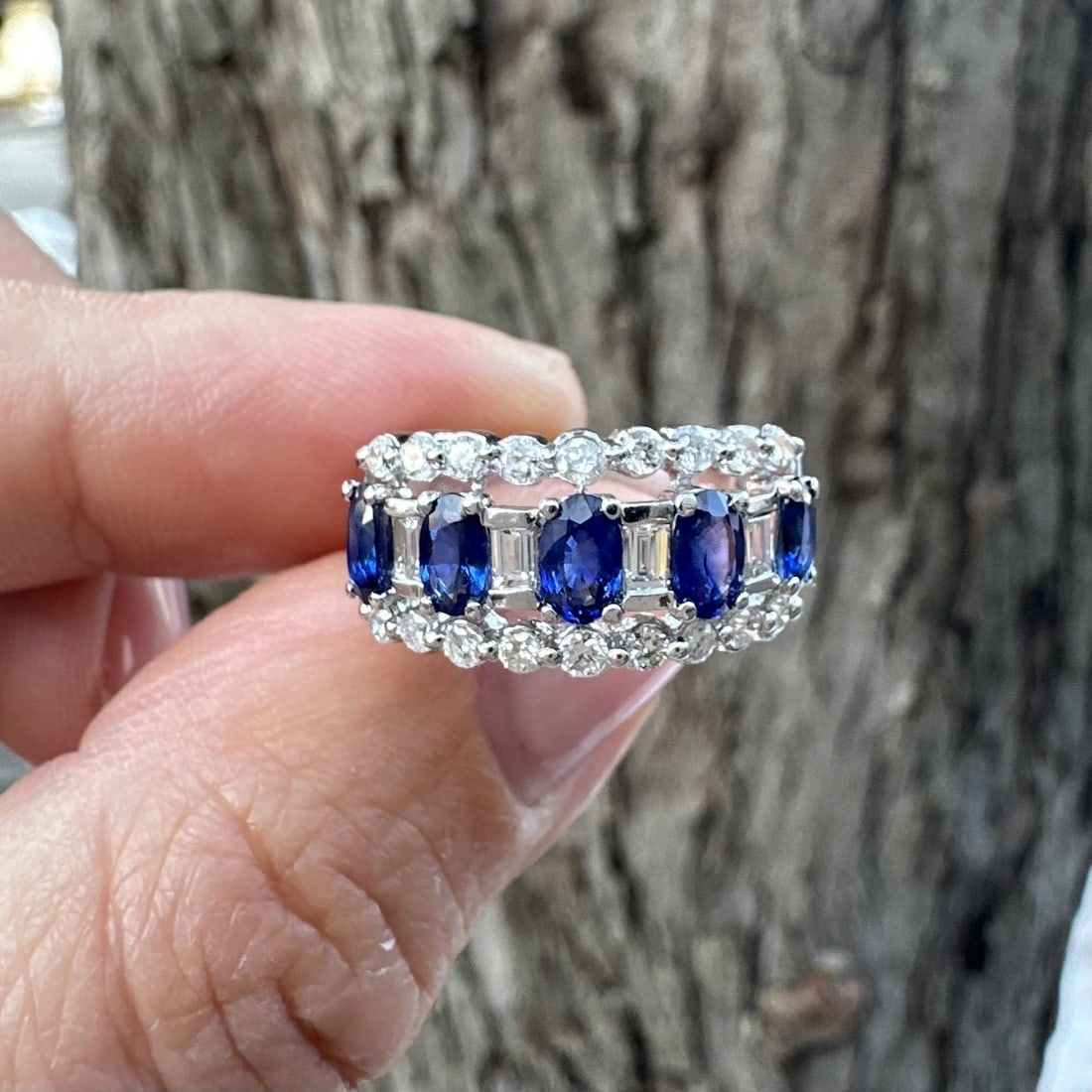 Oval Blue Sapphire and Diamond Band Ring in 18k White Gold 2.08ctw: Oval Blue Sapphire and Diamond Band Ring in 18k White Gold 2.08ctw This elegant band ring features five natural oval-cut royal blue sapphires, prong-set in solid 18k white gold. The sapphires are comp