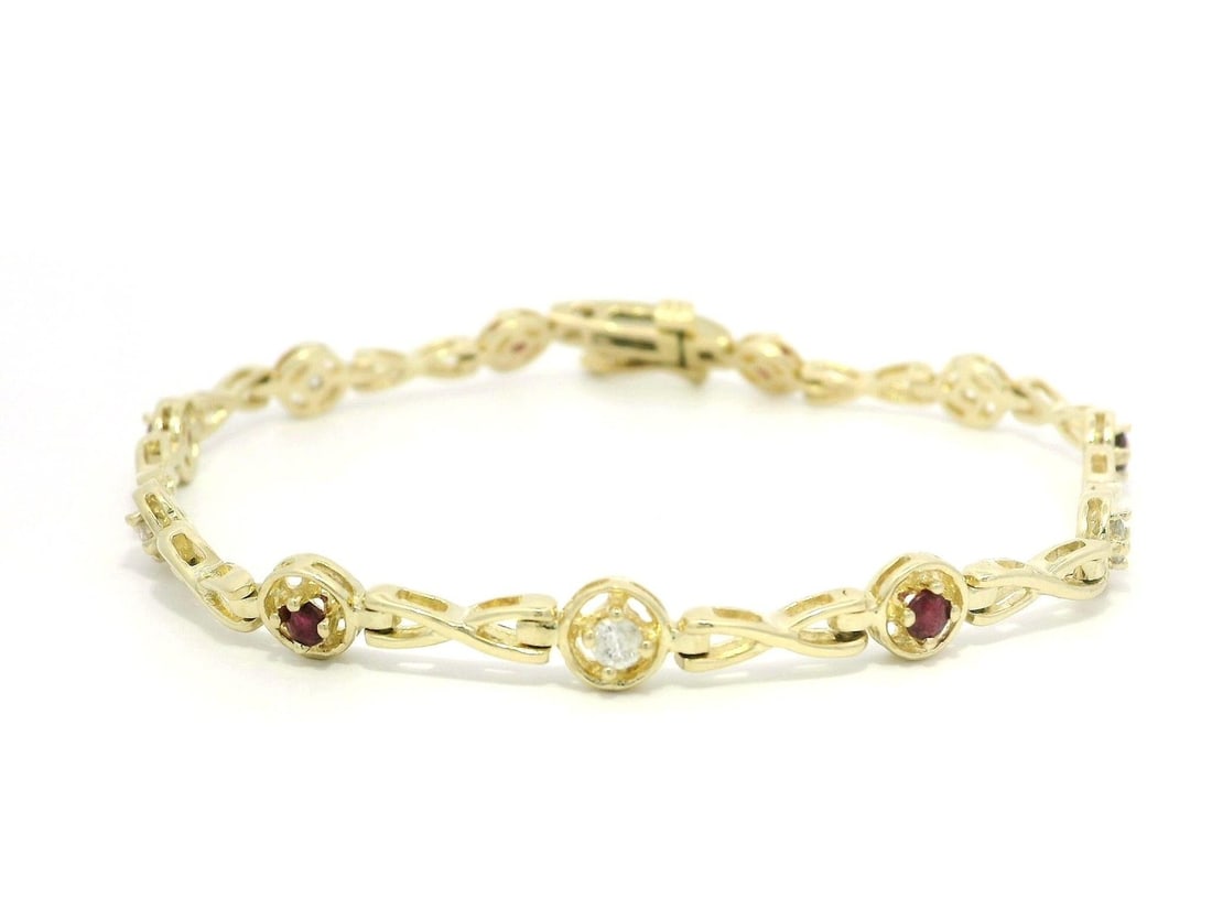 14k Yellow Gold .83ctw Ruby Diamond Infinity Bracelet 6.75in: 14k Yellow Gold .83ctw Ruby Diamond Infinity Bracelet 6.75in This exquisite bracelet features a stunning design combining alternating natural rubies and diamonds set in solid 14k yellow gold. The infi
