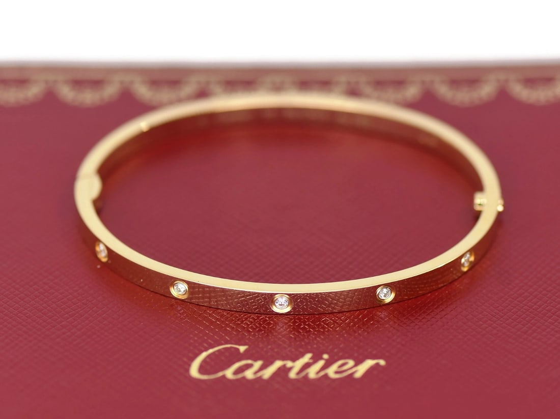 Cartier Love Small 18K Yellow Gold Bracelet with 10 Diamonds Size 16: Cartier Love Small 18K Yellow Gold Bracelet with 10 Diamonds Size 16 This Cartier Love bracelet is crafted from 18K yellow gold and features 10 diamonds. It is a small model bangle in size 16, designe