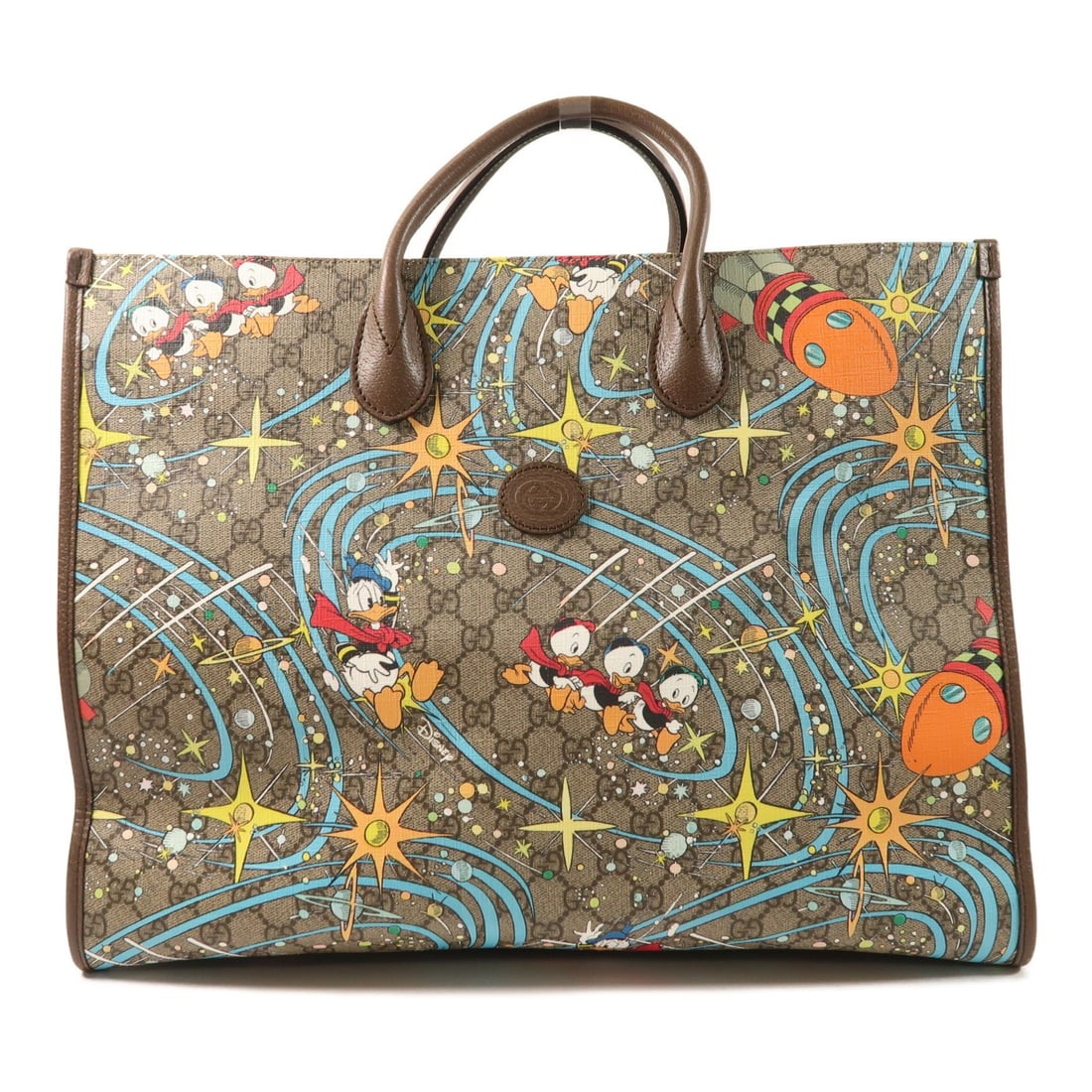 Gucci Donald Duck GG Brown Tote Bag with Gold Hardware: Gucci Donald Duck GG Brown Tote Bag with Gold Hardware This Gucci x Disney Donald Duck tote bag features a playful collaboration design crafted from brown PVC coated canvas with calfskin leather accen