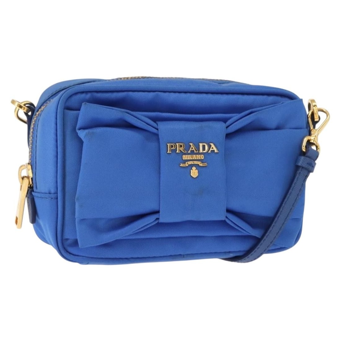 Blue Nylon Prada Bow Camera Crossbody Bag for Women: Blue Nylon Prada Bow Camera Crossbody Bag for Women The Prada Bow Camera Crossbody Bag is crafted from blue nylon and features a bow detail on the front. Designed for women, this compact crossbody bag