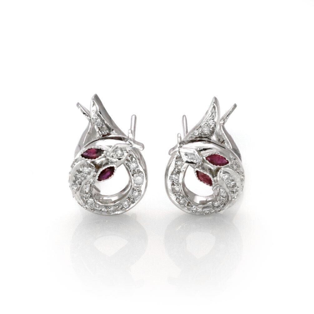 18k White Gold Stud Earrings with Diamonds and Rubies Coiled Clip Design: 18k White Gold Stud Earrings with Diamonds and Rubies Coiled Clip Design These vintage and antique stud earrings are crafted from 18k white gold and feature a combination of diamonds and rubies. The e