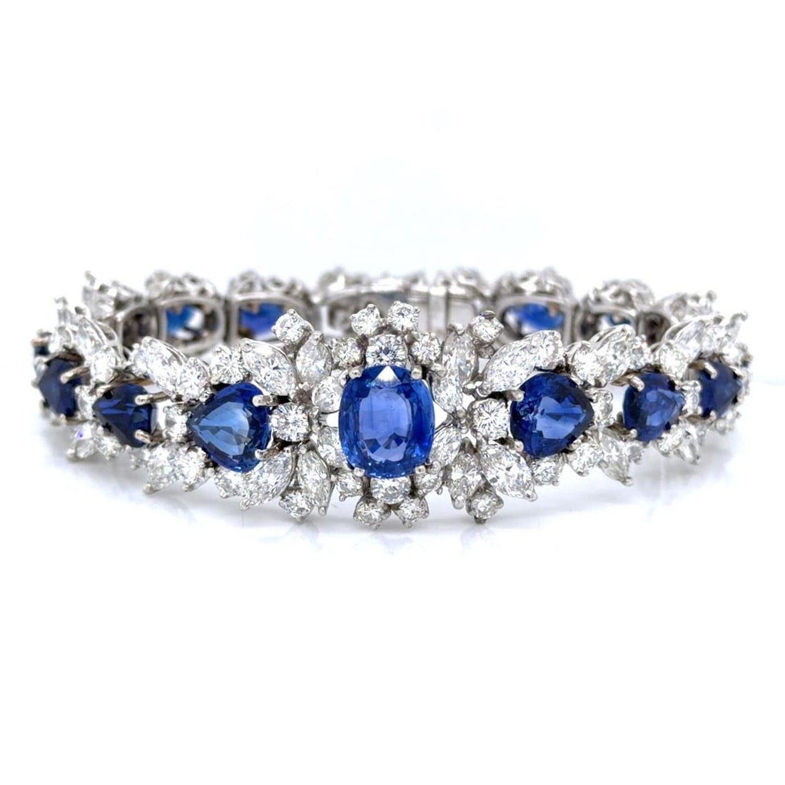 Platinum Bracelet with AGL Certified Sapphire and Diamond Accents from 1950s: Platinum Bracelet with AGL Certified Sapphire and Diamond Accents from 1950s This 1950's platinum bracelet features a center 3.56 ct AGL certified sapphire, complemented by 14 additional sapphires wit