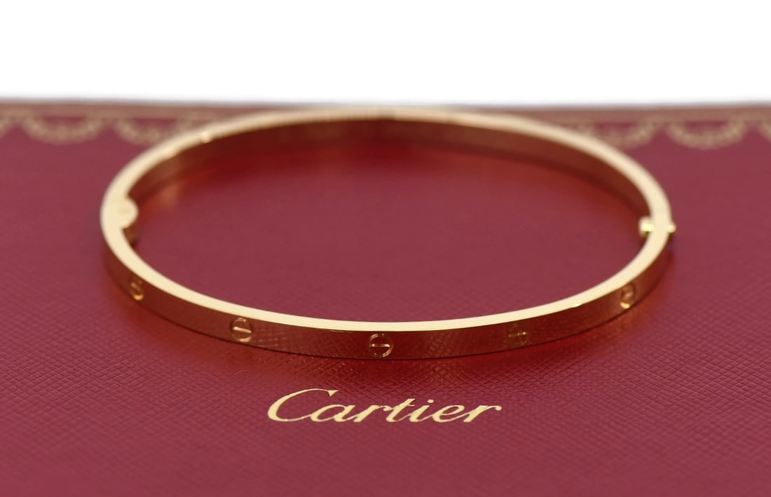 Cartier Love Bangle Bracelet 18K Yellow Gold Small Model Size 18 with Certificate: Cartier Love Bangle Bracelet 18K Yellow Gold Small Model Size 18 with Certificate This Cartier Love Bracelet is crafted from 18K yellow gold and features the iconic bangle design from the Love collect