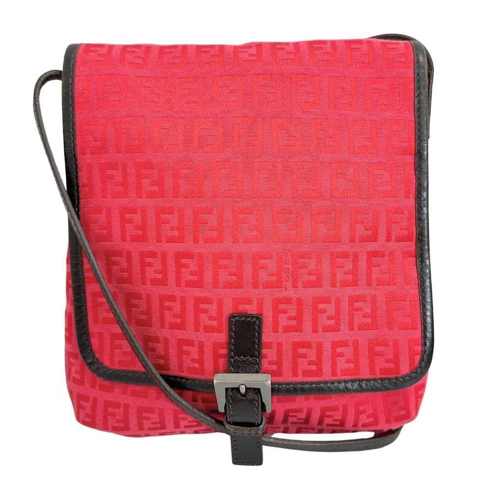 Fendi Red Canvas Crossbody Flap Bag 20cm by 24cm by 2.5cm: Fendi Red Canvas Crossbody Flap Bag 20cm by 24cm by 2.5cm This Fendi Flap Crossbody Bag is crafted from red Zucca canvas, designed for women. It features a compact rectangular shape with a flap closur