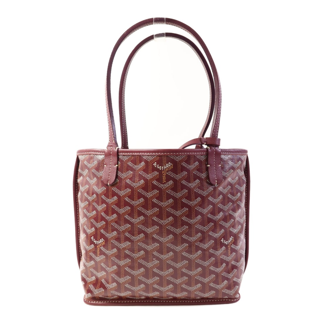 GOYARD Mini Anjou Tote Bag Burgundy Red PVC Coated Canvas: GOYARD Mini Anjou Tote Bag Burgundy Red PVC Coated Canvas This exquisite Goyard Mini Anjou Tote Bag is crafted from durable PVC coated canvas in a striking burgundy red. The tote bag features a well-s