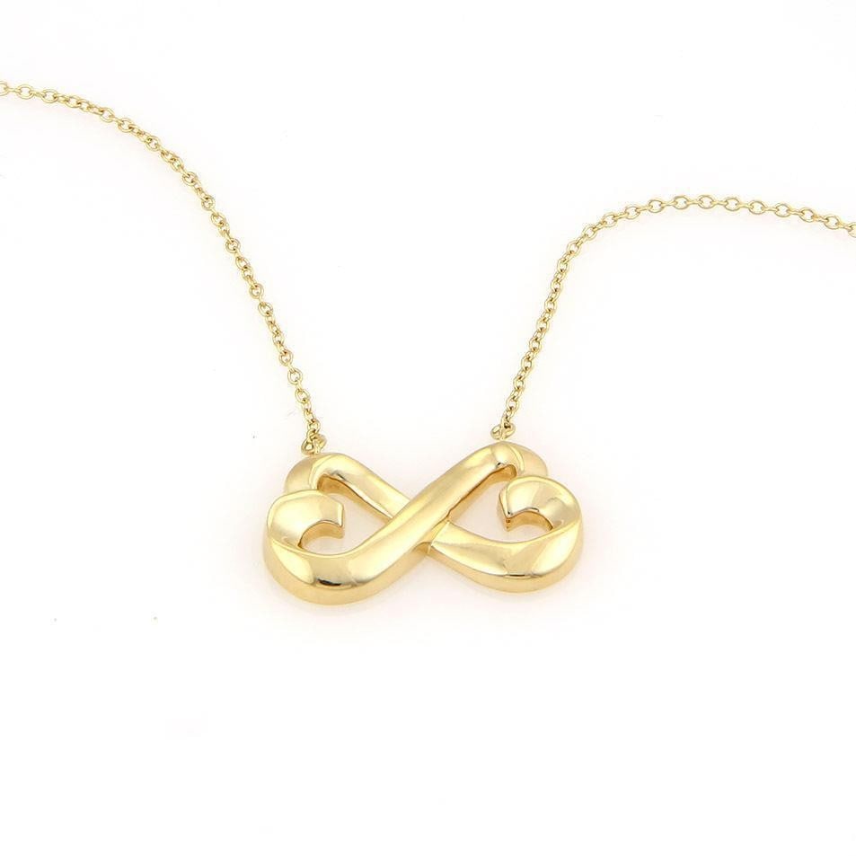 Tiffany & Co. Paloma Picasso 18k Gold Loving Hearts Necklace: Tiffany & Co. Paloma Picasso 18k Gold Loving Hearts Necklace Discover the elegance of this authentic Tiffany & Co. necklace designed by Paloma Picasso, featuring a stunning Loving Hearts pendant. Craf